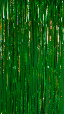 Vertical-Video-Full-Frame-Background-Shot-Of-Green-And-Gold-Tinsel-In-Studio-For-St-Patrick's-Day